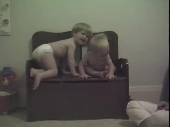 Authentic vintage footage shows two adorable brothers in diapers sitting on a toy box