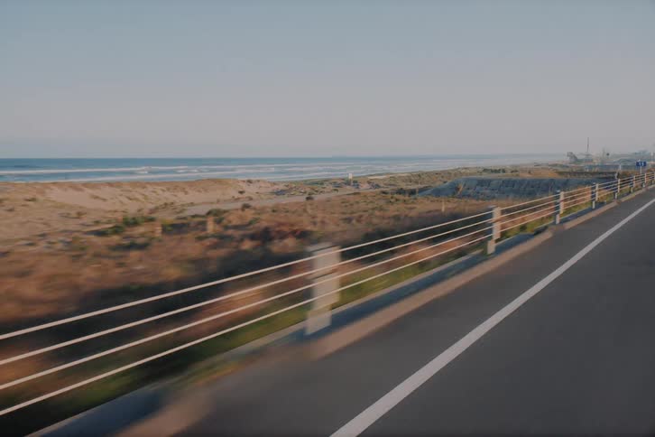 A scenic point-of-view drive along a coastal highway in Japan, with views of the sandy beach and ocean waves