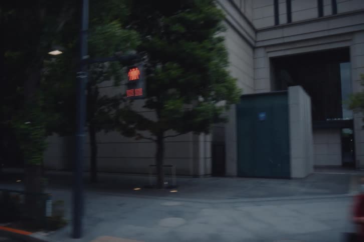 A moody tracking shot through the streets of Tokyo reveals the city's modern and historic architecture under an overcast sky