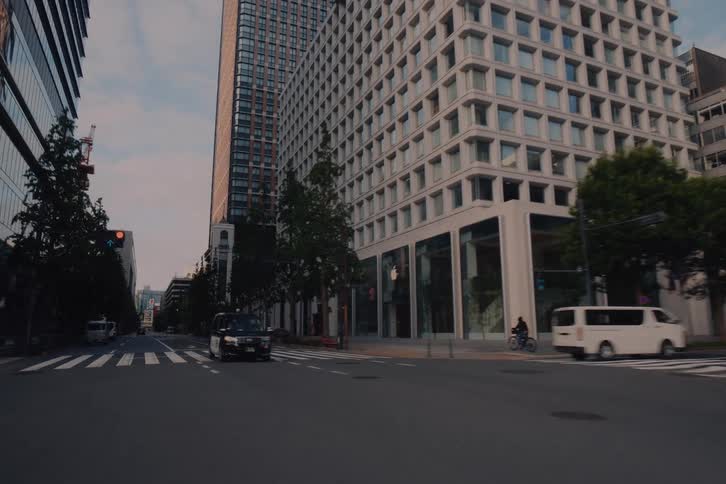 A serene drive through the unusually empty streets of Tokyo's Marunouchi district past Tokyo Station and modern skyscrapers at dawn