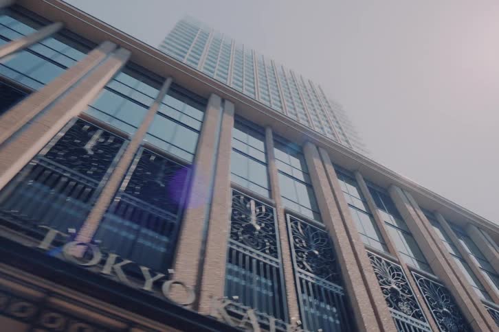 A dreamy, upward-looking slow-motion drive-by of various city skyscrapers, transitioning from a cloudy to a sunny, vintage-film style day