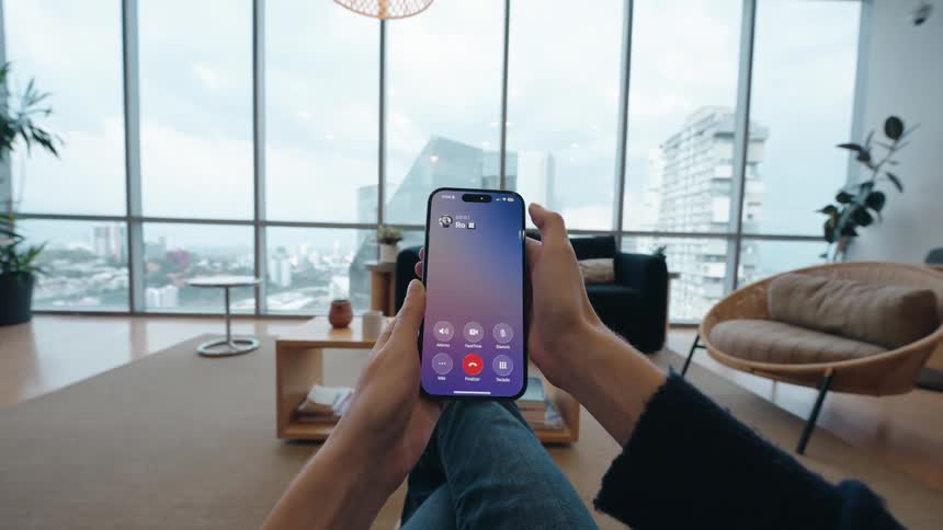 First-person view of a person scrolling on their phone in a modern apartment until an incoming call prompts them to angrily throw the device away