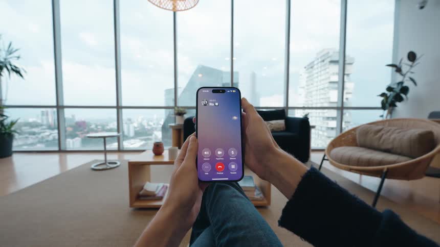 POV shot of a person scrolling their smartphone, receiving a call, and then angrily throwing it away in their modern apartment
