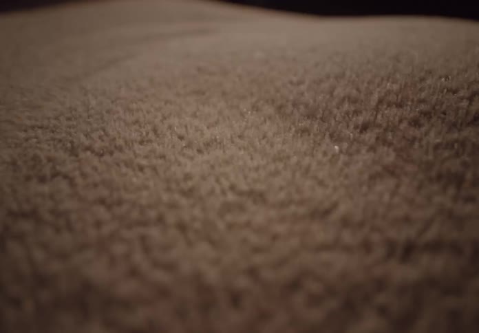 Macro shot of sand particles vibrating and dancing in intricate Cymatic patterns due to sound frequencies
