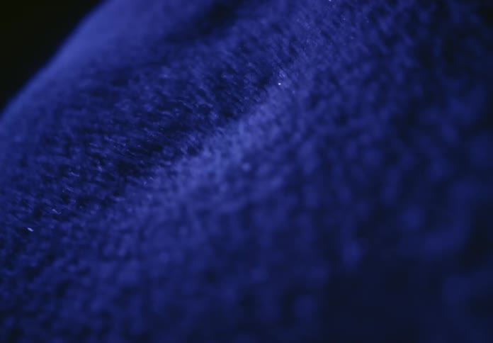 A mesmerizing macro shot of blue particles dancing and creating intricate patterns due to sound vibrations
