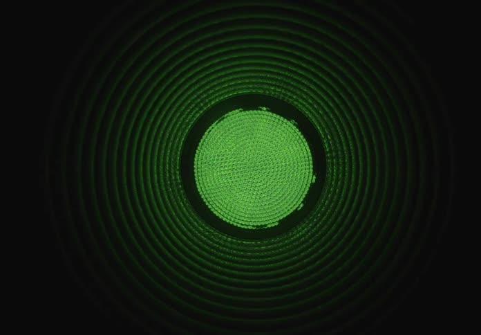 Abstract colorful pulsating light circles create a hypnotic tunnel effect on a black background