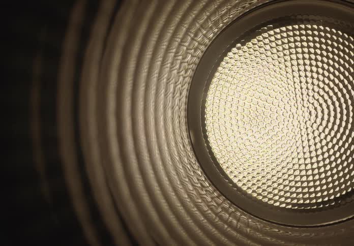 A mesmerizing dolly shot through a dark, ribbed tunnel reveals a bright, circular light at the end