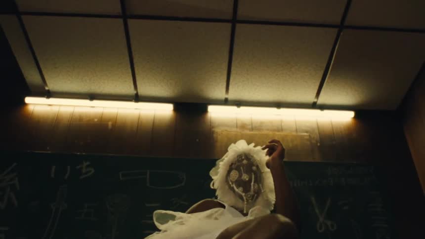 Low-angle surreal montage of a person training with a heavy bag while wearing an ornate white mask