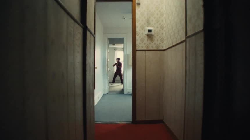 Contrasting scenes show a formal martial arts class outdoors and a solo practitioner training in a rundown hallway