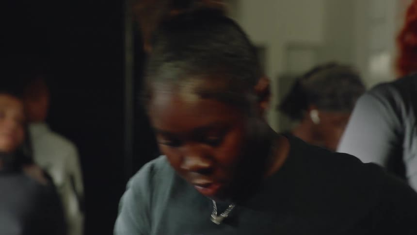 Close-up of a determined woman pushing through a difficult cardio exercise in a fitness class