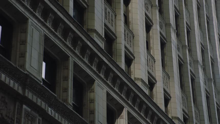 An upward angle captures the detailed, classic architecture of a multistory city building