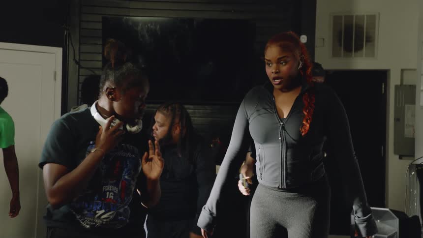 A group of young Black dancers practices a synchronized choreography routine in slow motion