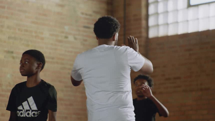 Dancers of all ages gather in a community dance class to learn footwork choreography in slow motion