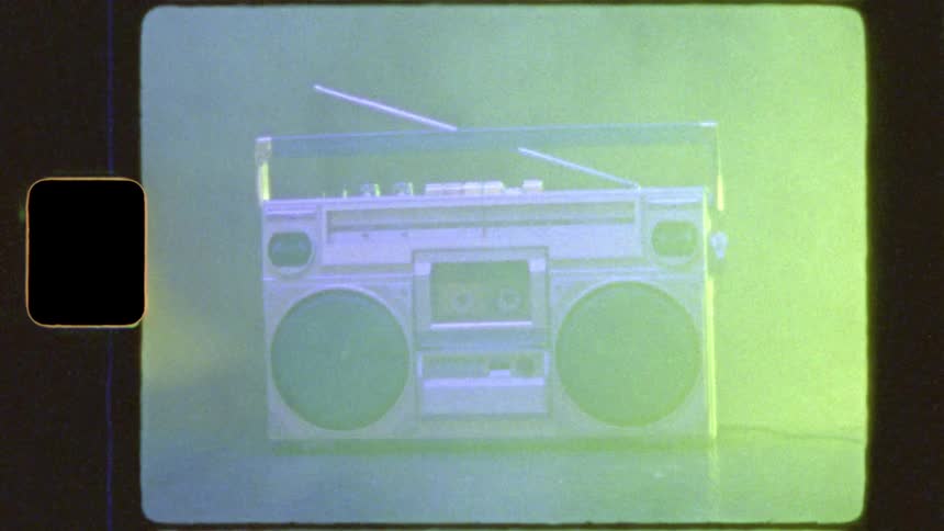 A vintage 1980s boombox is bathed in colorful flashing lights with a retro old film aesthetic