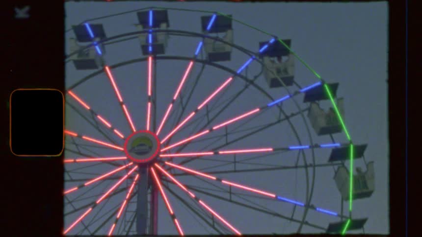 A vintage film-style shot captures a neon-lit Ferris wheel slowly turning against the dusky evening sky at a carnival