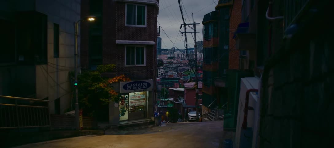 A still shot of a quiet street in a dense residential neighborhood of Seoul, South Korea at dusk