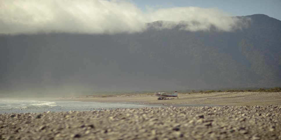 Ocean waves wash ashore a rocky beach