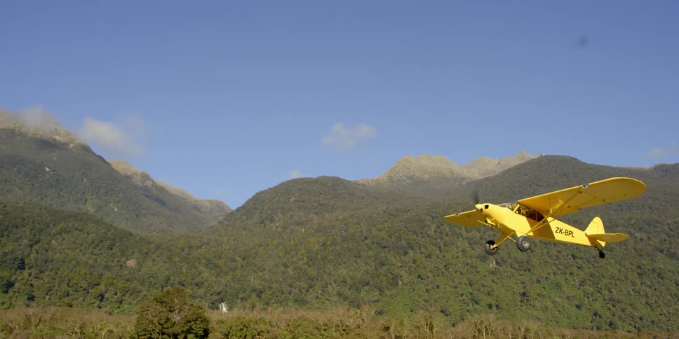 Small yellow airplane takes off