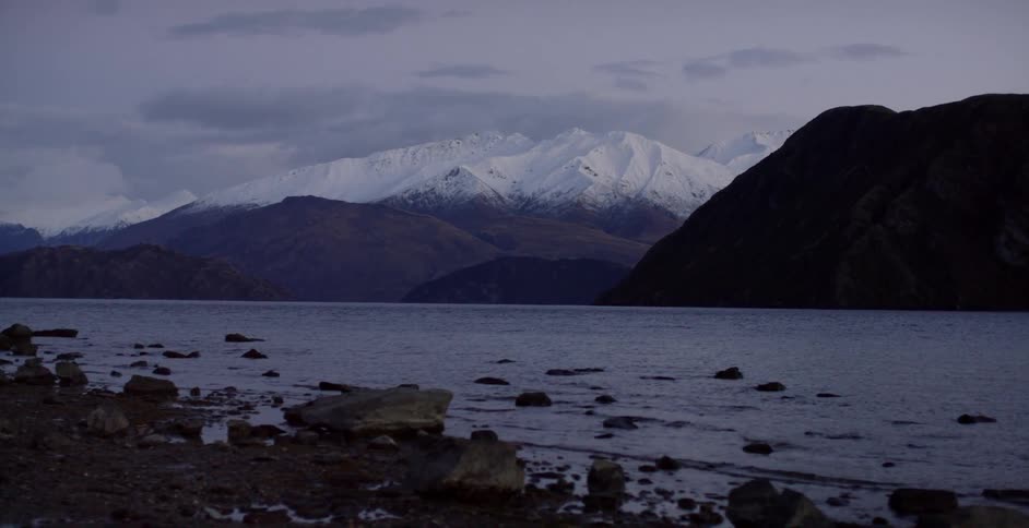 A calm lake sits before a mountain range