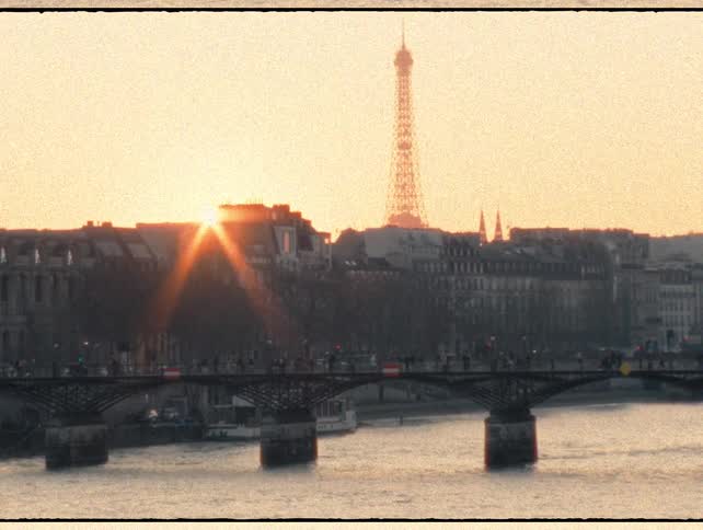 A nostalgic Super 8 film captures a golden sunset over the Pont des Arts bridge and the Seine River in Paris, with the Eiffel Tower in the distance