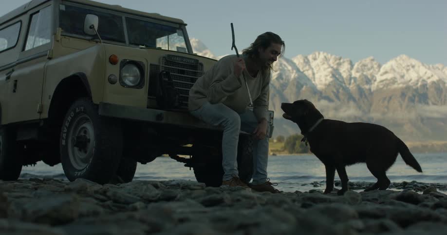 A man shakes his dogs hand