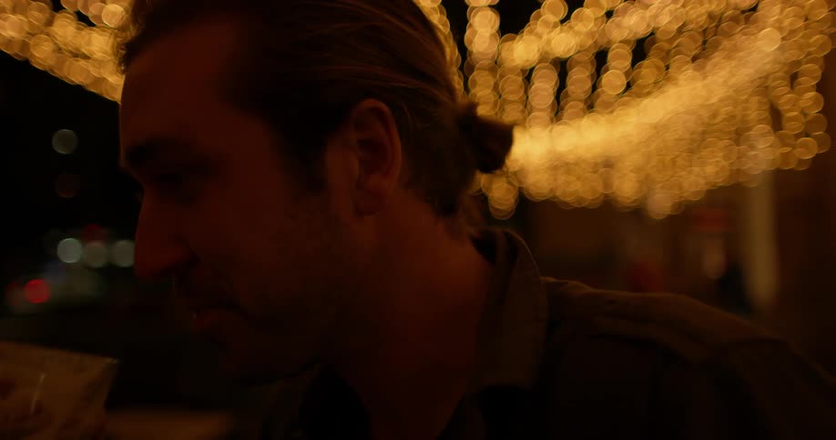 A man takes a drink and talks