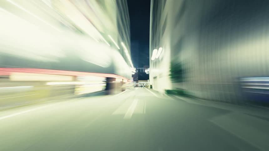 POV hyperlapse captures a high-speed drive through the glowing streets of a modern city at night