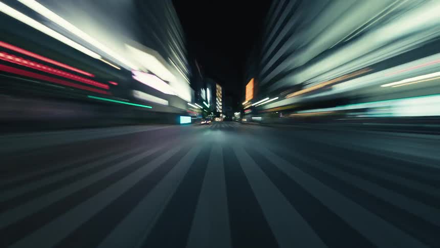 An exhilarating first-person view hyper-lapse journey through the neon-lit streets of a bustling city after dark