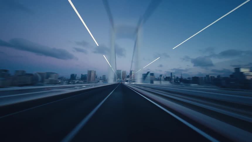 Futuristic hyper-lapse from a car driving over a city bridge at twilight, creating dazzling light trails