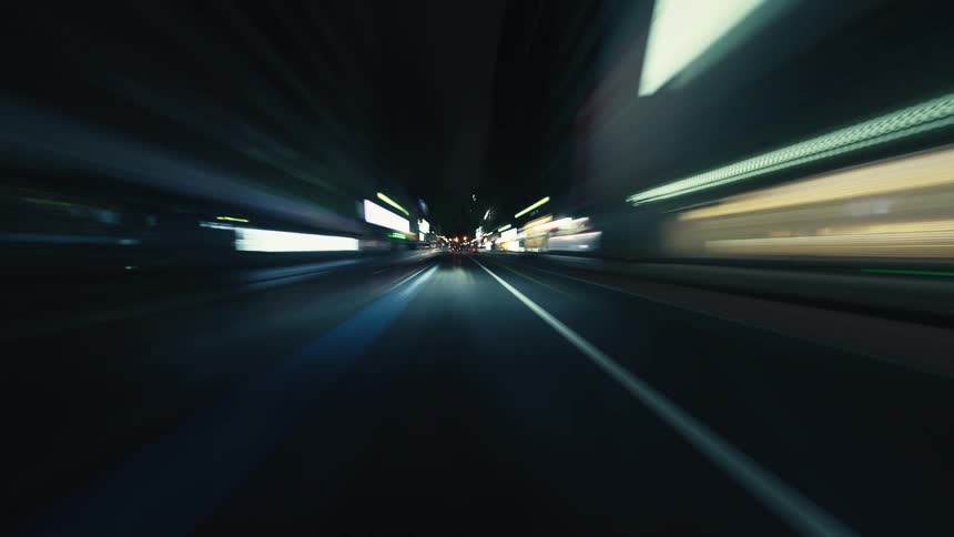 A high-speed hyper-lapse journey through a neon-lit city at night, seen from a driver's point of view