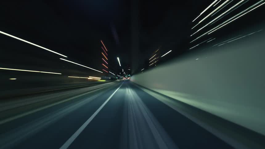 An immersive hyperlapse journey through illuminated city streets at night from a driver's perspective