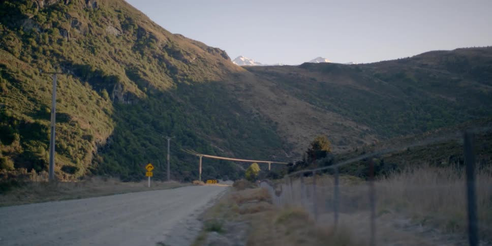 The road is empty near this mountain