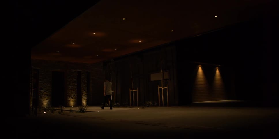 A man walks in a dimly lit area