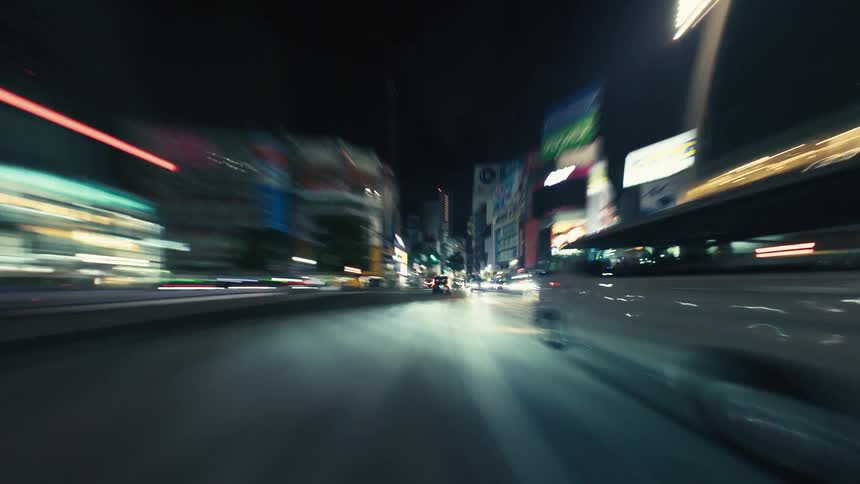 An exhilarating first-person POV hyperlapse of driving through a bustling city at night, with neon lights and traffic blurring into vibrant streaks of color