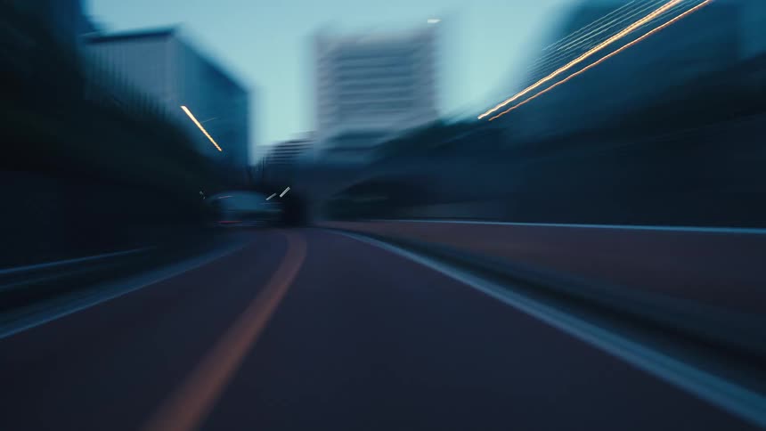 Experience a high-speed, futuristic drive through the light-streaked highways and tunnels of a modern metropolis at night