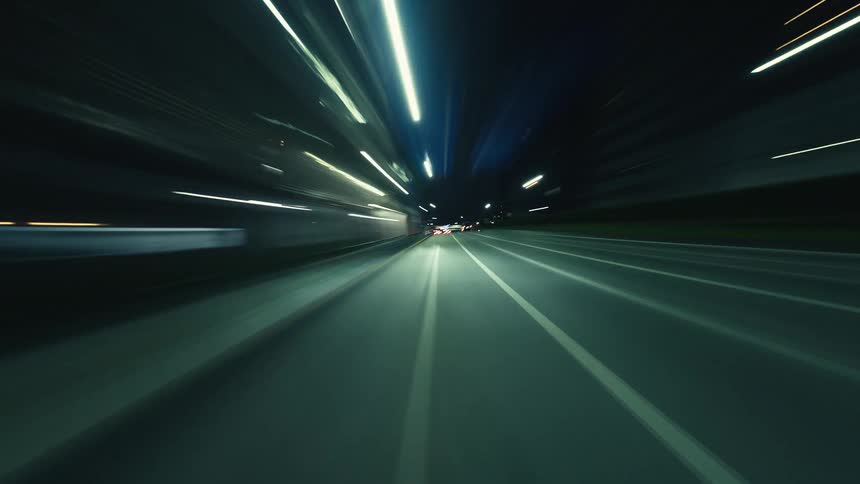 A stunning POV hyperlapse shows a high-speed journey through a city at night with long exposure light trails