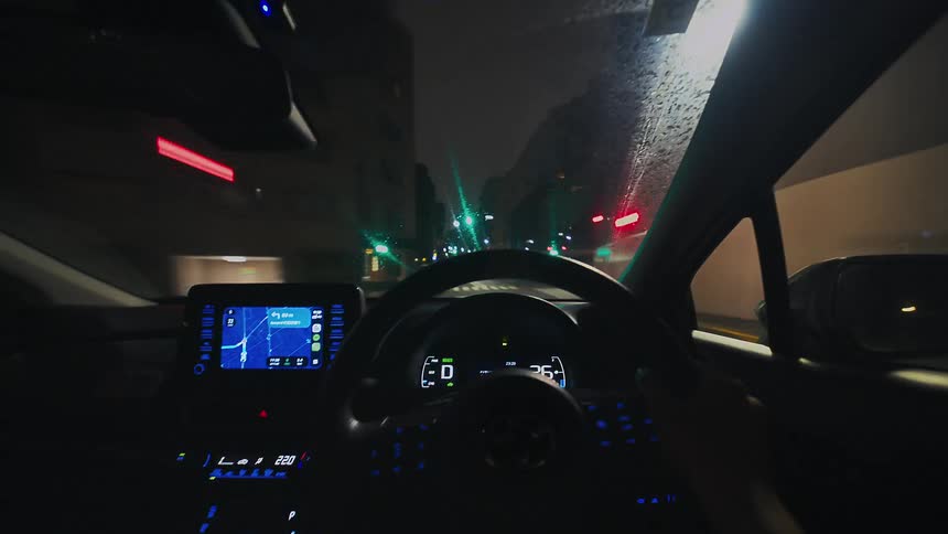 A first-person perspective hyperlapse captures a thrilling drive through city streets at night, with dashboard lights glowing and street lights blurring into streaks