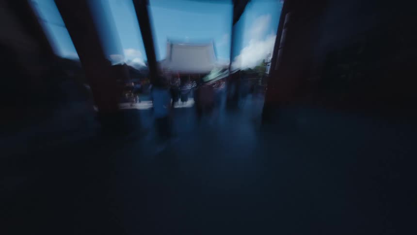 A surreal motion-blur hyperlapse captures a whirlwind POV journey through the crowded streets leading to a traditional Japanese temple in Tokyo