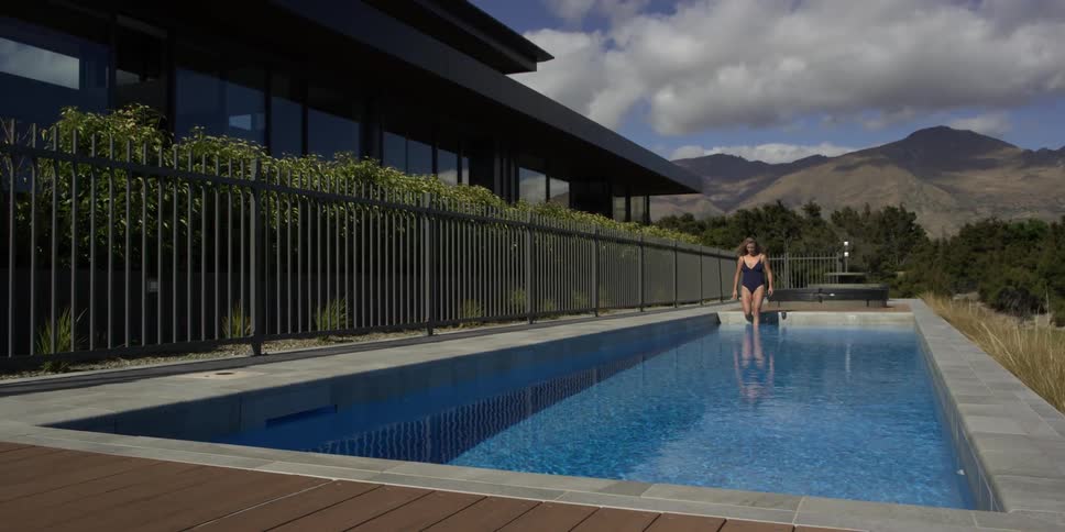 A woman steps into a private pool