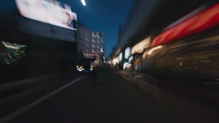 A dizzying first-person hyperlapse speeds through the light-streaked streets of a Japanese city late at night