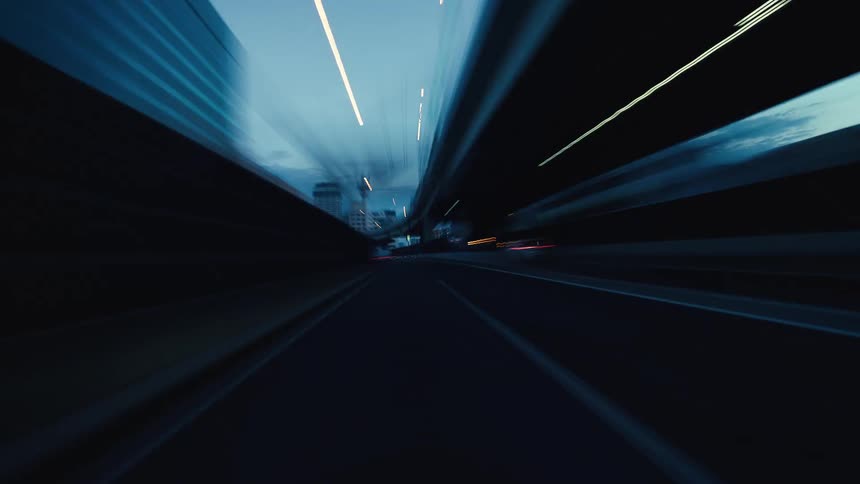 A dynamic first-person point-of-view hyperlapse of driving on a city highway at dusk