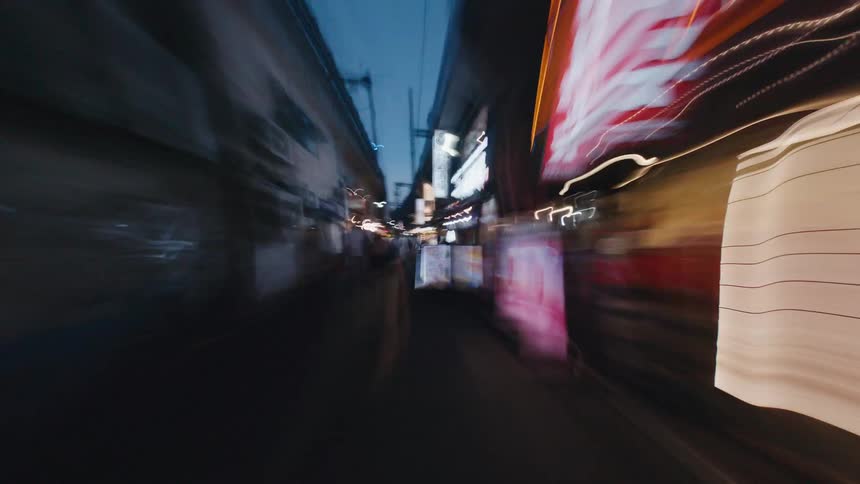 A chaotic first-person hyperlapse races through bustling city streets at night, transforming neon signs and streetlights into vibrant, abstract light trails