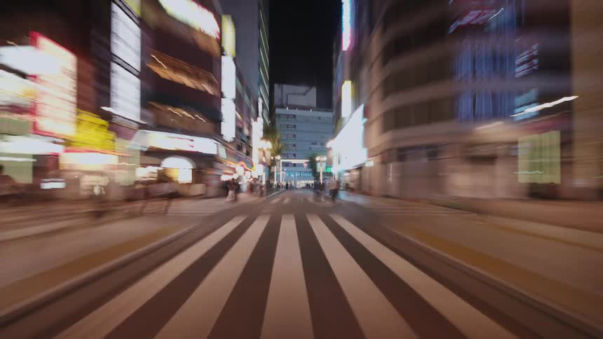 A dizzying hyper-lapse drive through the vibrant, neon-lit streets of a Japanese city at night