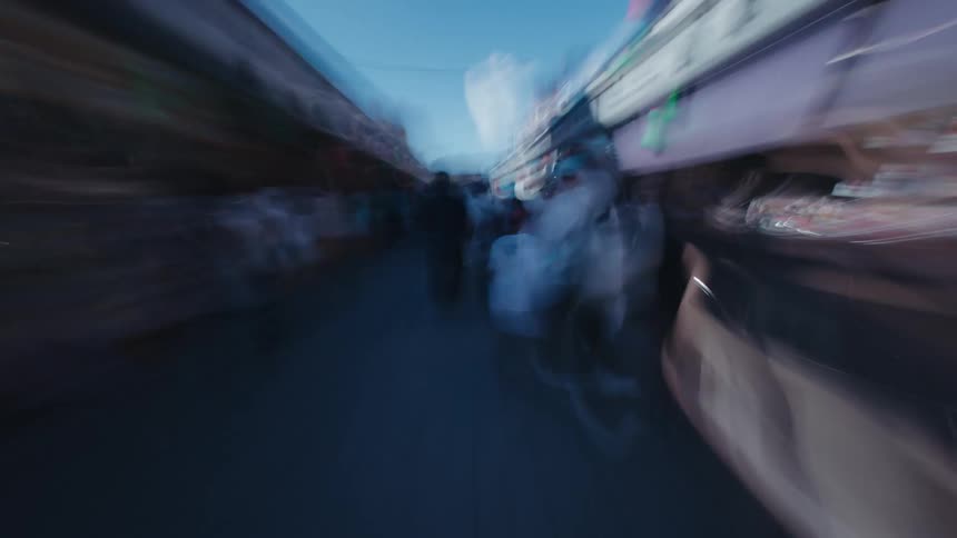 A dreamlike hyperlapse captures the energetic rush of walking through a crowded outdoor market street