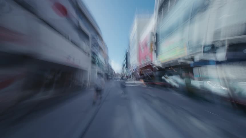 A stylized point-of-view hyperlapse rushes through a narrow street in a Japanese city, creating a disorienting, dream-like visual effect