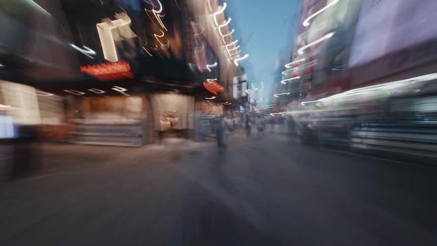 A disorienting hyperlapse rushes through the bustling, neon-lit streets of a vibrant Asian city at dusk