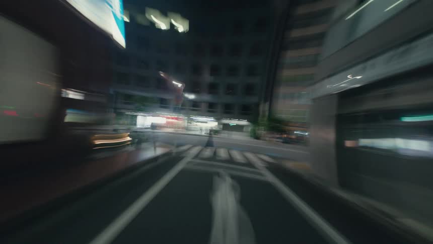 An abstract first-person view hyperlapse captures a high-speed journey through the electric streets of a city at night