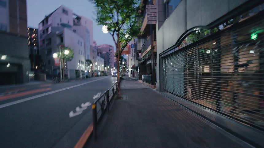 A fast-paced, first-person point-of-view journey through the quiet streets of a Japanese city at dusk