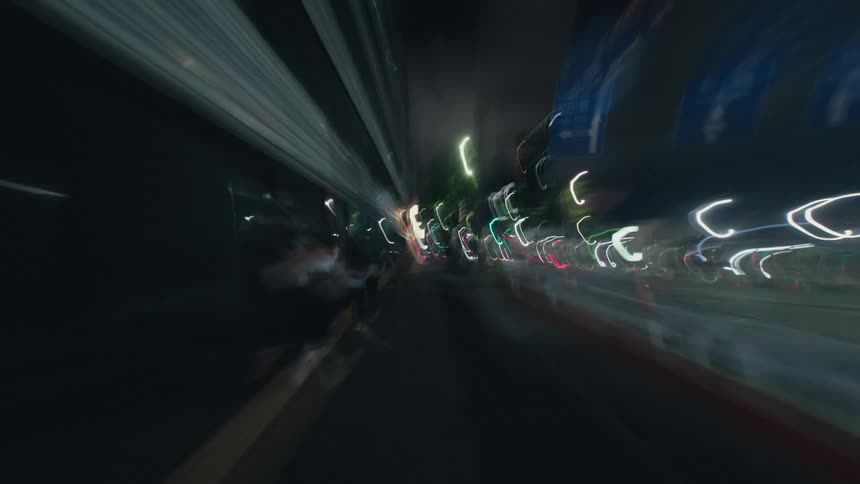 A first-person point-of-view hyperlapse of walking through a bustling city street in Tokyo at night, with motion blur creating vibrant light trails