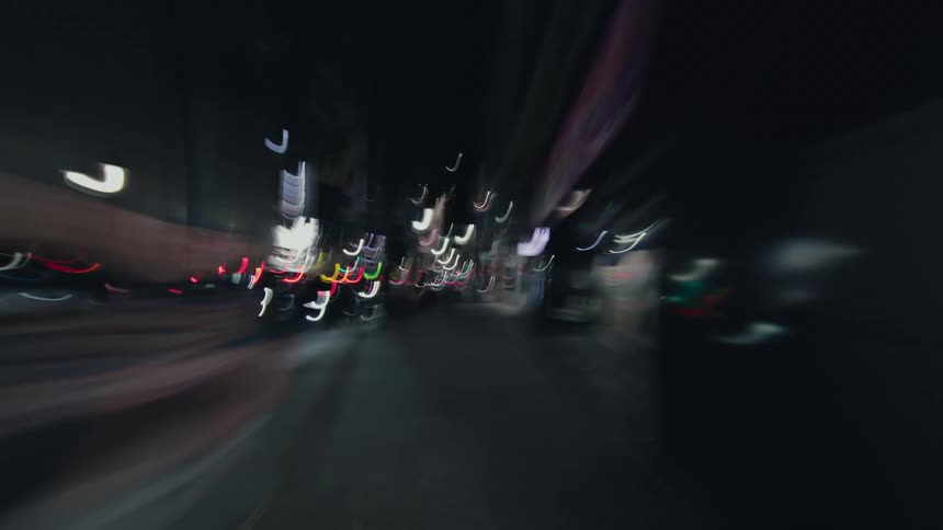 A dizzying first-person hyperlapse speeds through the vibrant, light-streaked streets of Tokyo at night